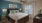 a bedroom with a bed and a fan