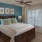 a bedroom with a bed and a fan