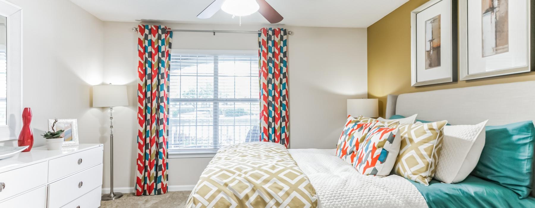 a bedroom with a fan and a bed