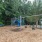 a playground with trees and a fence