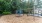 a playground with trees and a fence