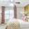 a bedroom with a fan and a bed