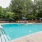 a swimming pool with trees in the background