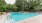 a swimming pool with trees in the background