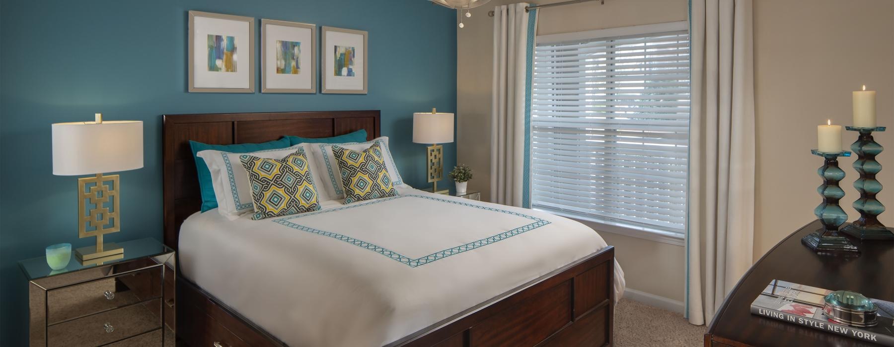 a bedroom with a bed and a fan