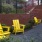 a group of yellow chairs in a garden