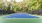 a tennis court with trees in the background
