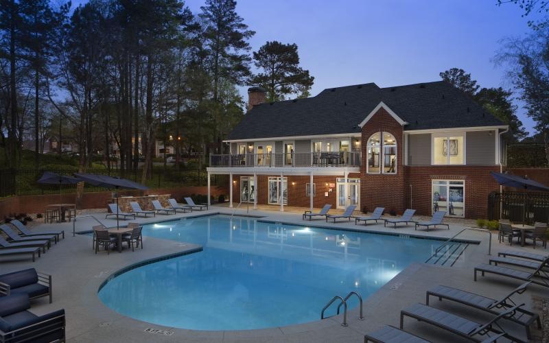 a swimming pool in front of a clubhouse