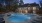 a swimming pool in front of a clubhouse