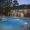 a swimming pool in front of a clubhouse
